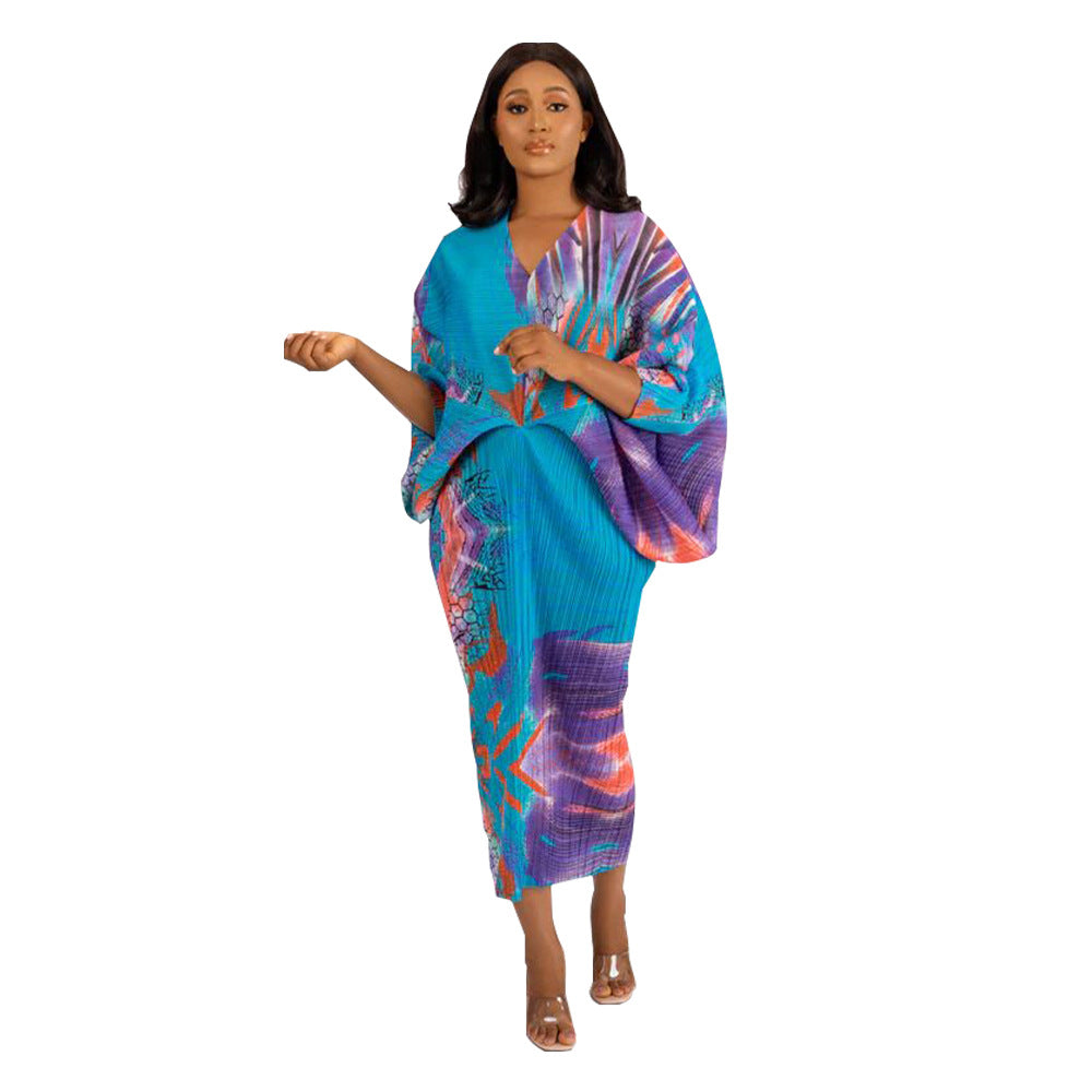 Pleated batwing V neck abstract print midi dress on a standing model, front view