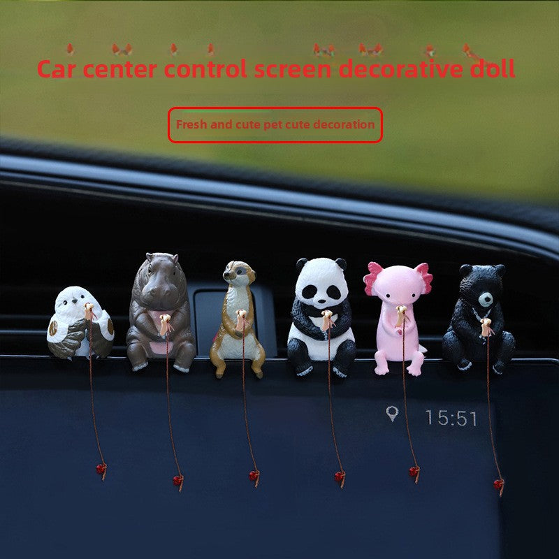 Six painted resin fishing animals in a row on a car centre screen with lines hanging down