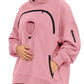 Pink oversized fleece hoodie with a round chest pocket, arched zipper and a zip pocket on the sleeve