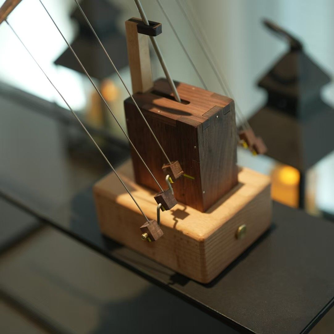 Side angle of the wooden desk figurine on its flat weighted base