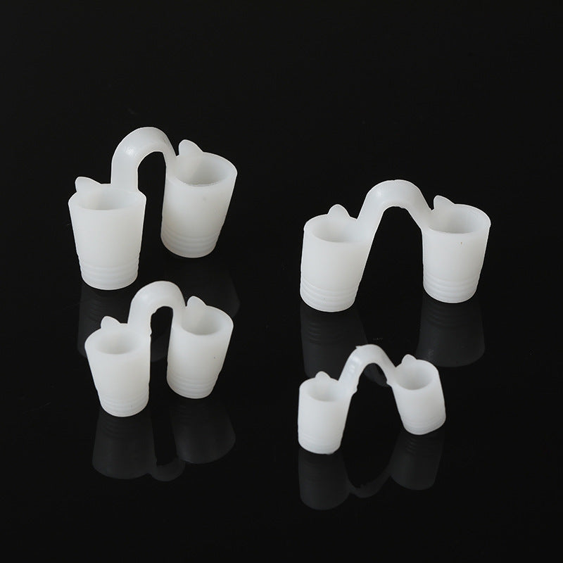 Four soft white solid silicone nose vents in graded sizes on a black background