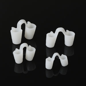 Four soft white solid silicone nose vents in graded sizes on a black background