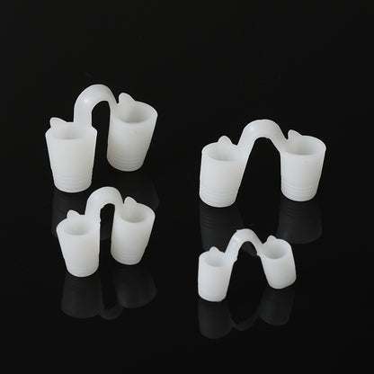 Four soft white solid silicone nose vents in graded sizes on a black background