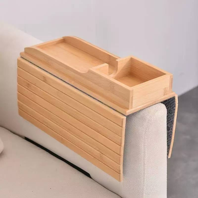 Natural bamboo slatted tray draped over a sofa arm with a two-section organizer tray on top