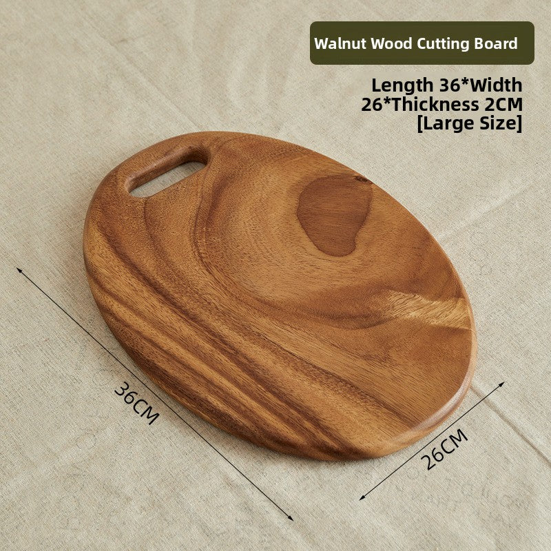 Walnut board with a large round hole handle shown hanging on a hook