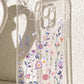 Clear TPU phone case with a purple wildflower print shown on a phone