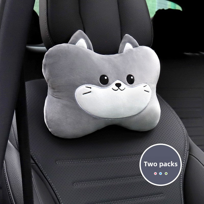 Gray cat cartoon headrest pillow with a white muzzle on a black car seat, two pack badge