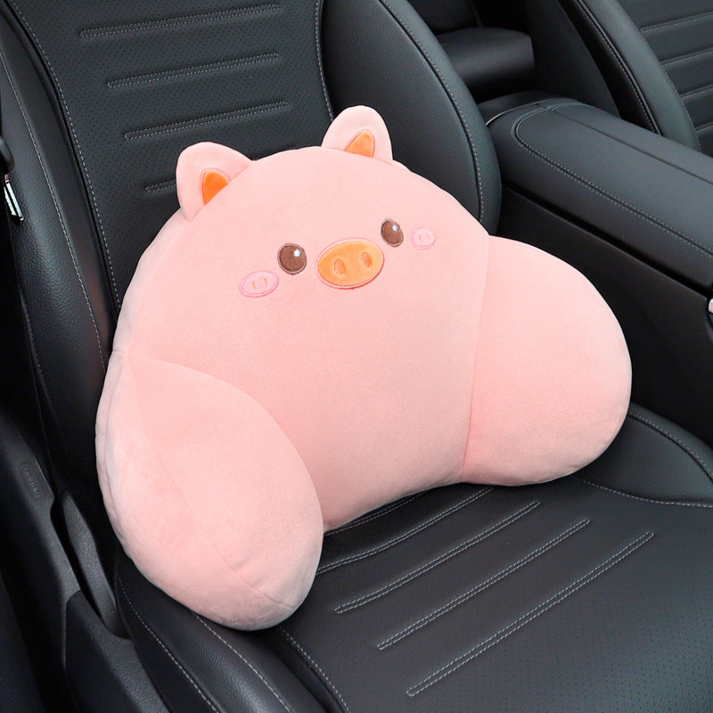 Pink pig lumbar support pillow with a snout resting on a black car seat
