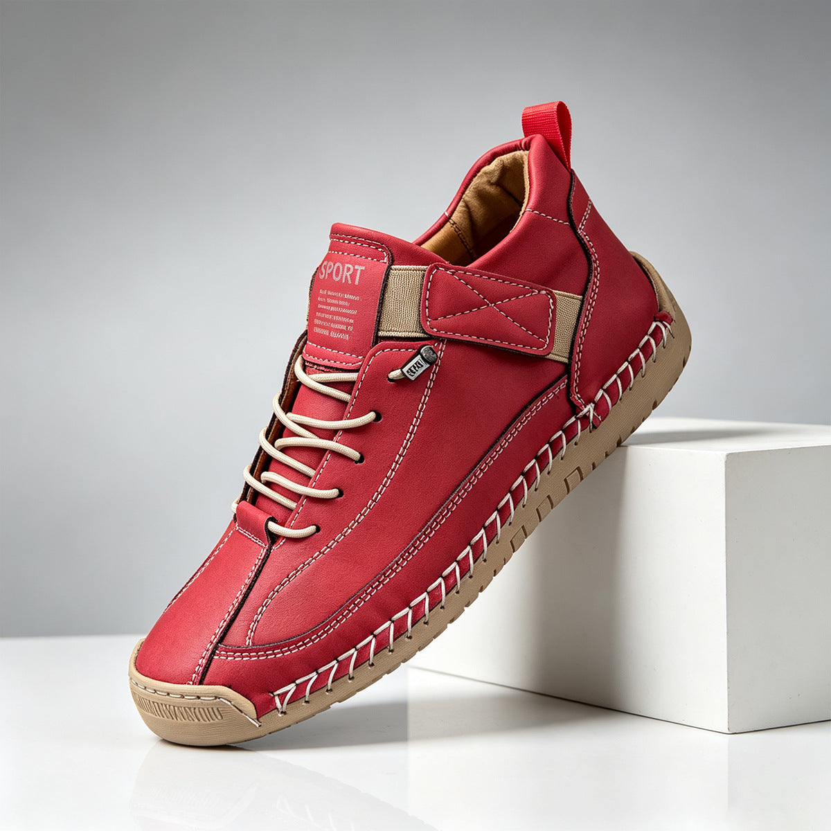 Hand-stitched casual shoe shown from the heel and pull tab