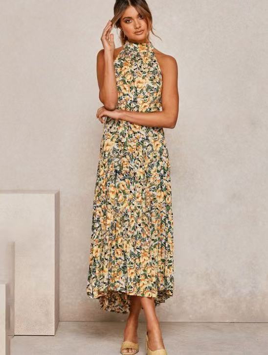 Yellow floral halter neck sleeveless tiered swing maxi dress worn by a model