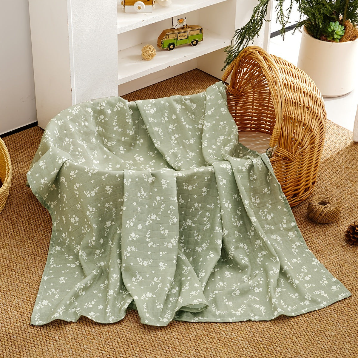 Pure cotton muslin swaddle blanket rolled up, showing the airy gauze texture and printed design
