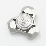 Triangular metal fox fidget spinner with pink and blue splatter finish, full view