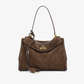Suede leather tote bag carried on the shoulder during a daily commute