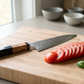 The Damascus knife produces clean even tomato slices on a board