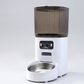Smart pet feeder with built-in camera and transparent food hopper on a clean studio background