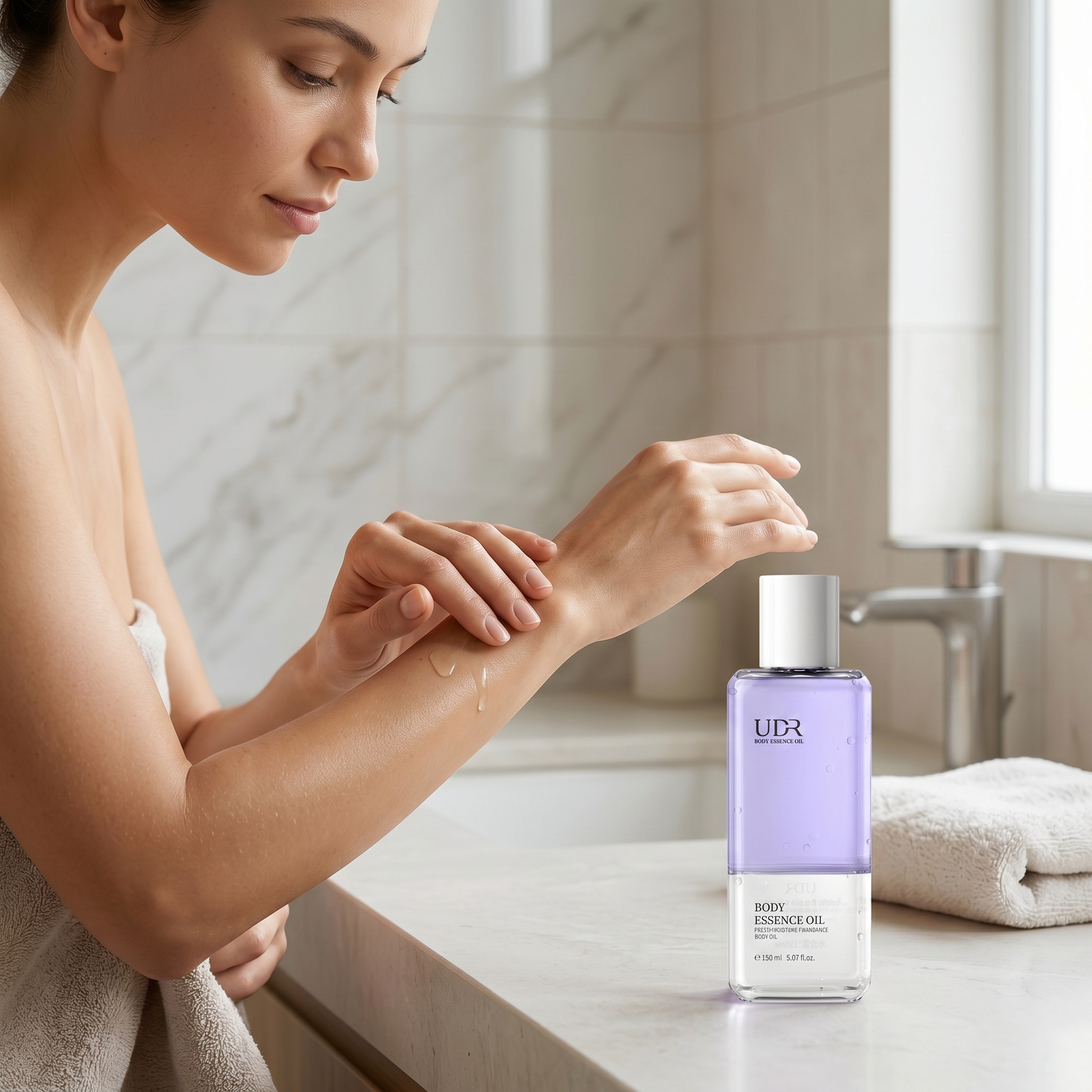 Woman applying the UDR body essence oil to her forearm in a bright bathroom, skin looking hydrated and soft