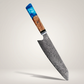 VG10 Damascus chef knife with blue resin and burl wood handle on a premium studio background