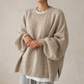 Women's knitted oatmeal puff sleeve sweater shown on model over a white tee