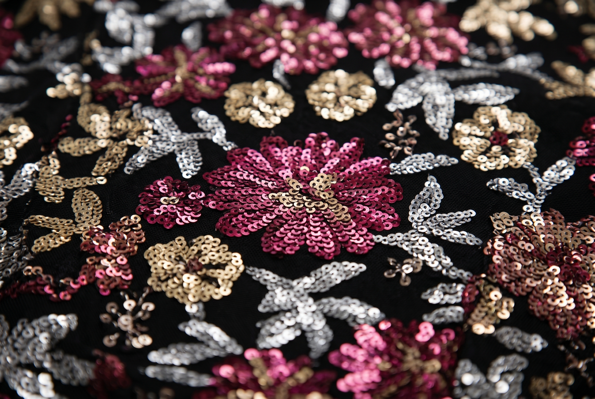 Macro close up of the multicolor floral sequin fabric on the evening gown
