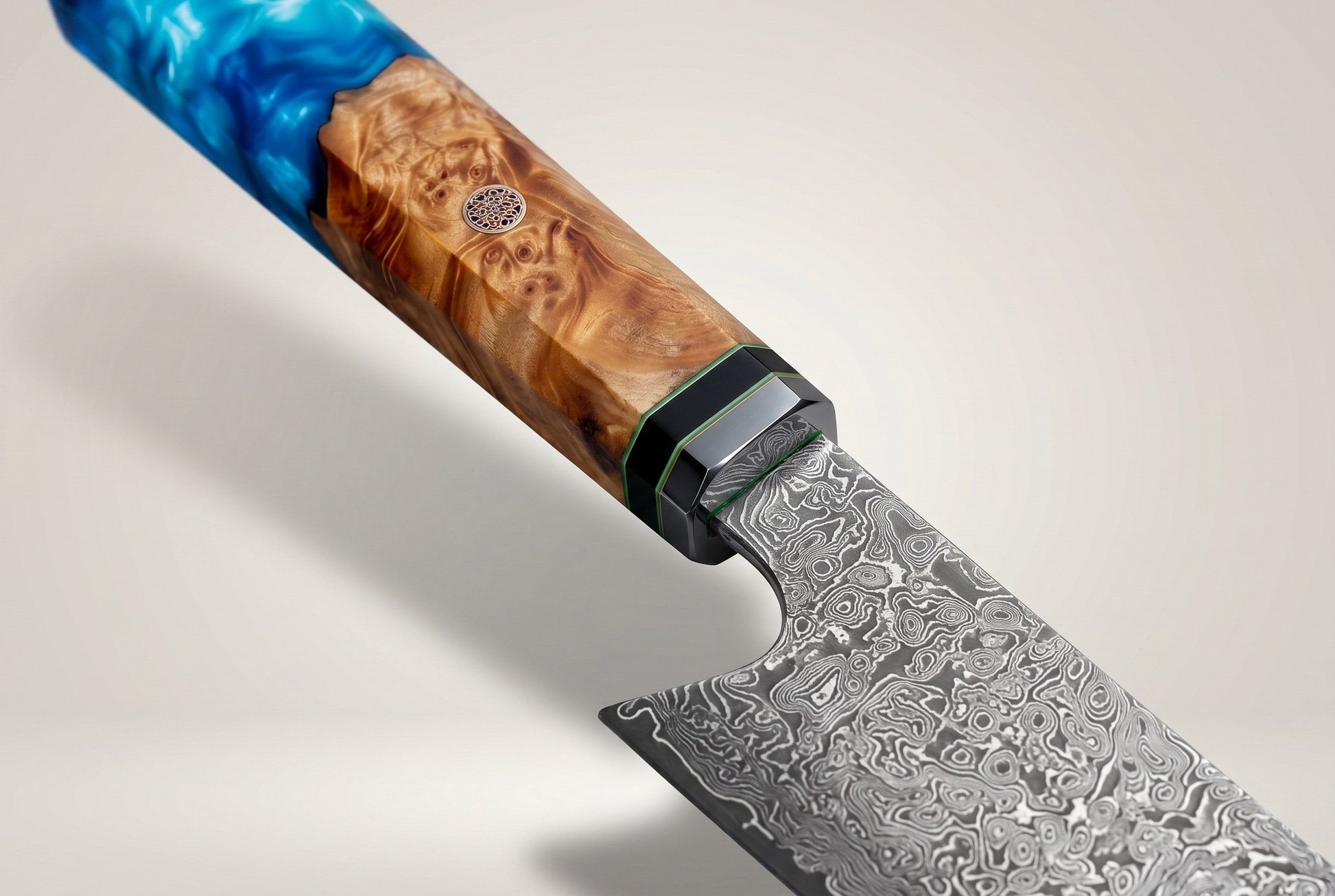 Close up of the knife handle showing blue resin, burl wood, black collar bolster and mosaic pin