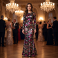 Woman wearing the black floral sequin long sleeve evening gown at an evening gala