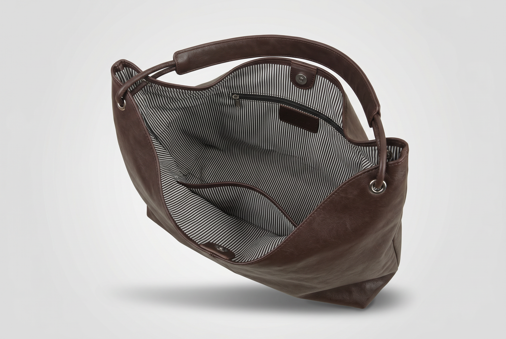 Open interior of the leather tote showing the pin stripe polyester lining and inner pockets