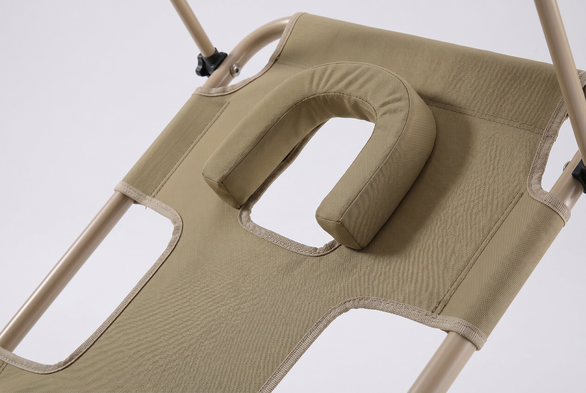 Close up of the cushioned face hole and padded headrest on the foldable sun lounger