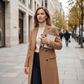 Woman without a tote awkwardly carrying her phone notebook and keys in her arms