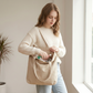Woman searching for a small item lost at the bottom of a plain ordinary tote bag
