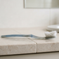 An old worn plastic toothbrush with splayed bristles on a bathroom counter