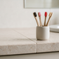 Fresh bamboo toothbrushes standing in a holder on a clean bathroom counter