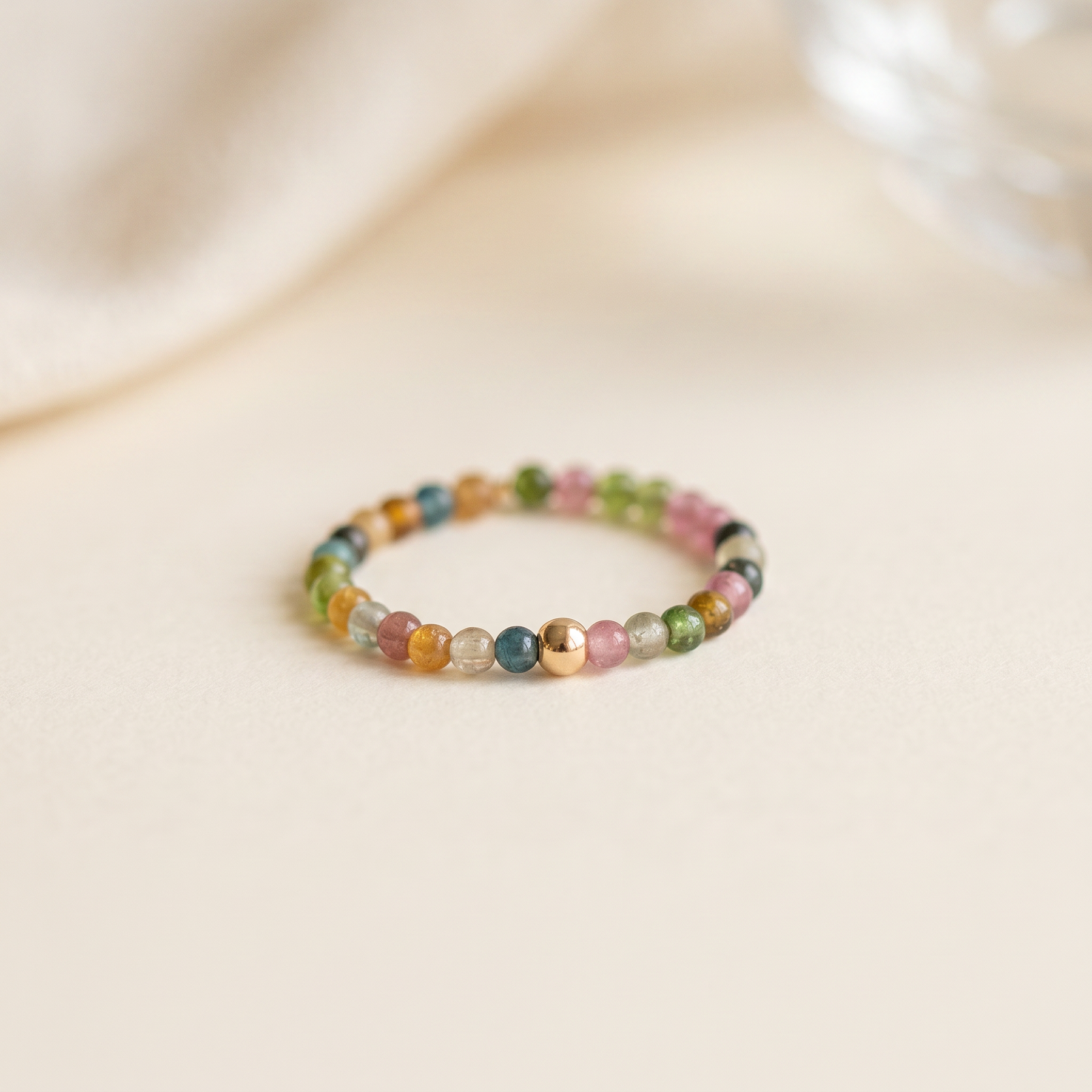A delicate stretch ring of real rainbow tourmaline