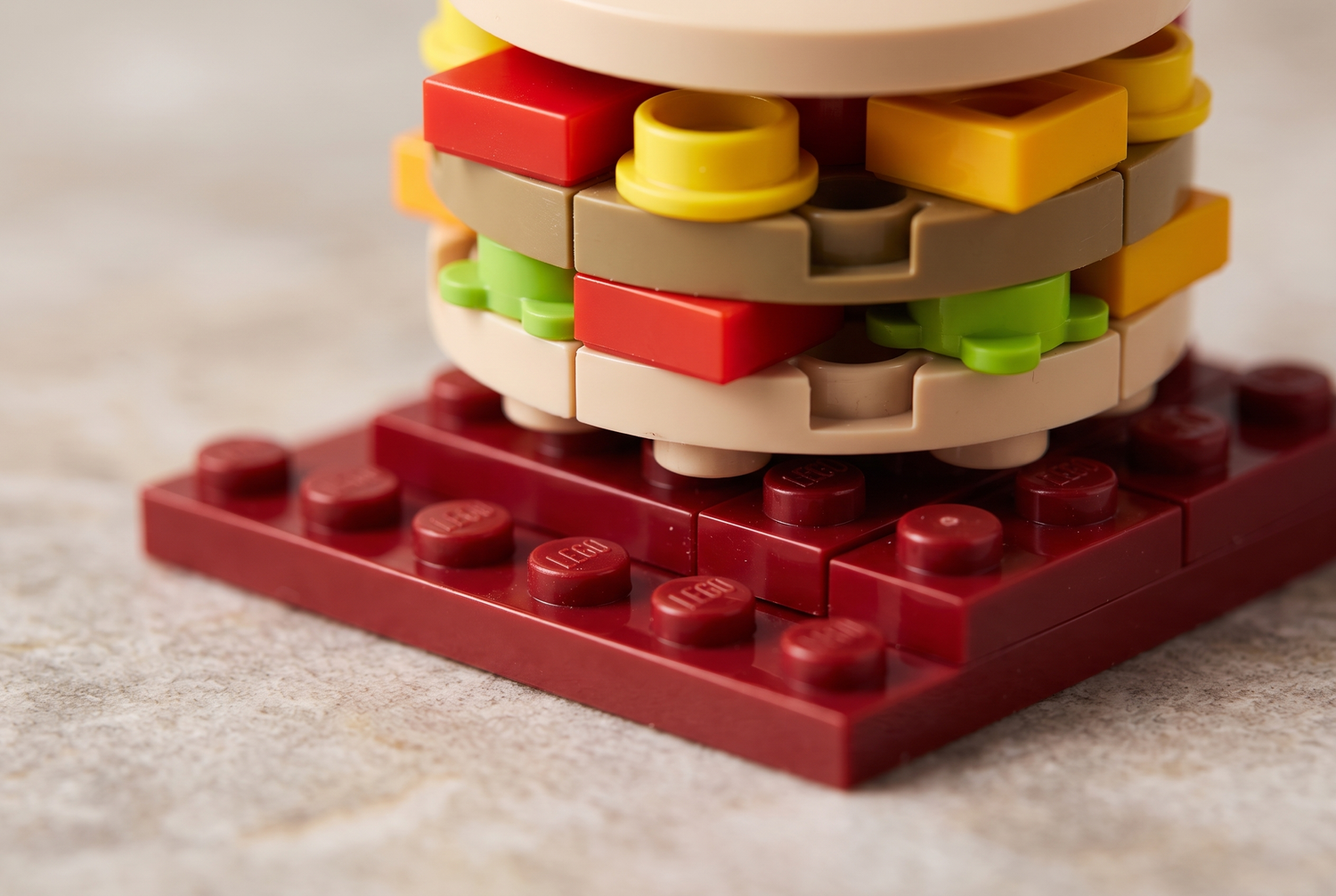 Macro of the rooftop burger sculpture and interlocking bricks of the McDonald themed shop