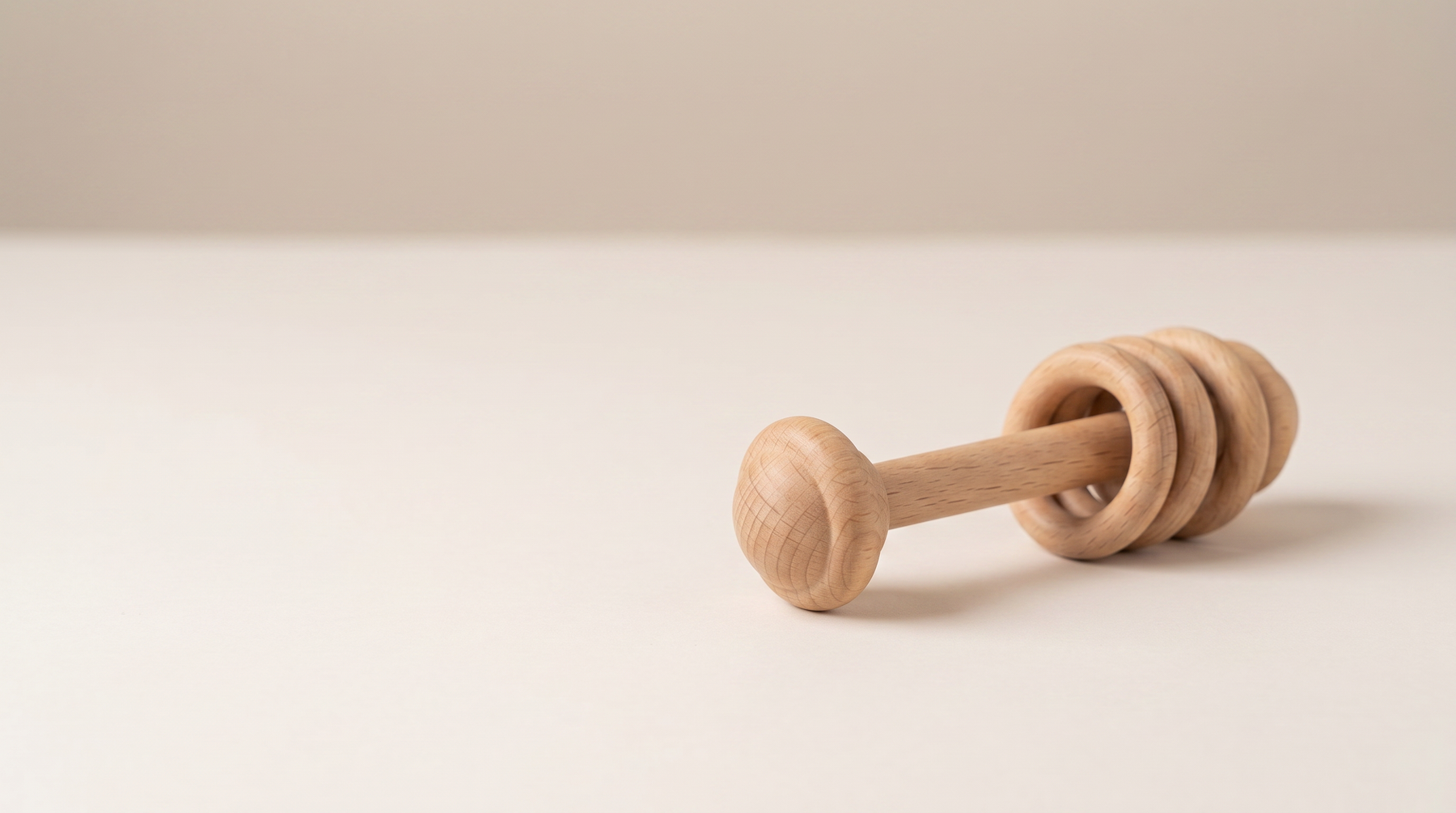 Introducing Wooden rattle and teether shaped for small hands: