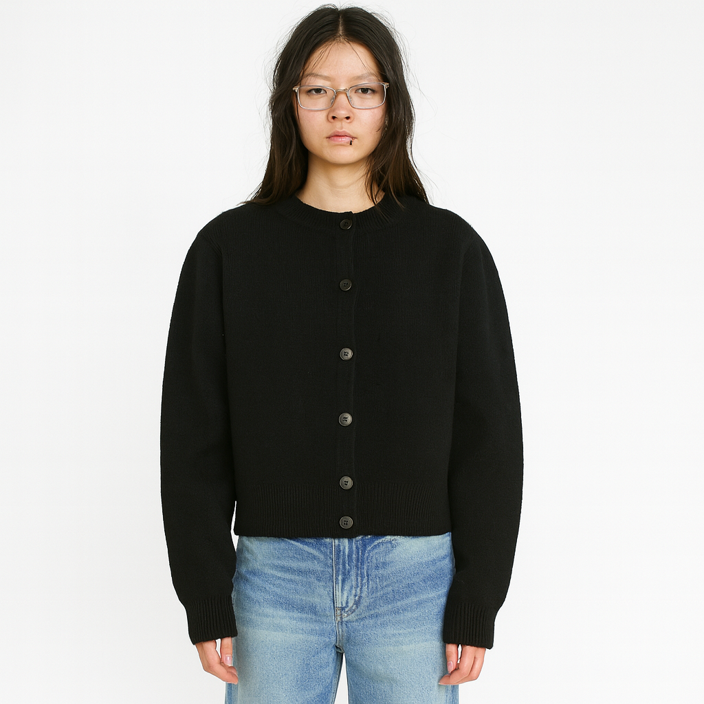 Side angle of the cropped knit cardigan showing the waist-length hem