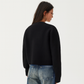 Front view of the cropped knit cardigan showing the full button placket
