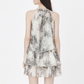 Floral tiered halter mini dress shown in an in-use summer moment