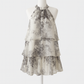 Side angle of the halter mini dress showing the open shoulders and tie neckline