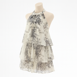 Floral tiered halter mini dress worn in a warm-weather lifestyle setting