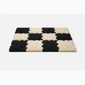 Modular shaggy rug tiles laid beside a bed as a soft floor mat