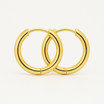 Pair of 18K gold circle earrings resting in an open velvet pouch