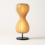 Twisted petal spiral lamp, front view of the wood slat hourglass shade on a slim base