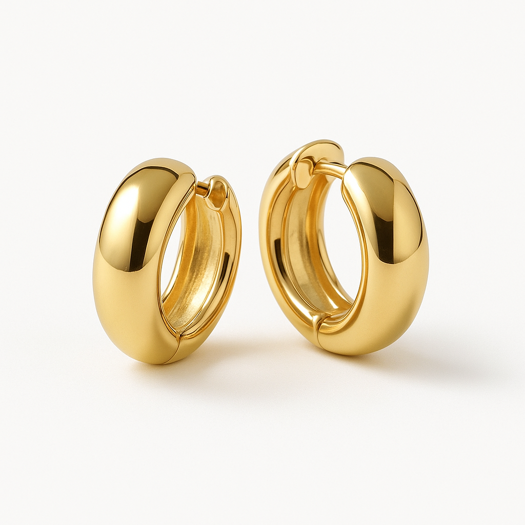 Front view of solid gold hoops held against pale linen