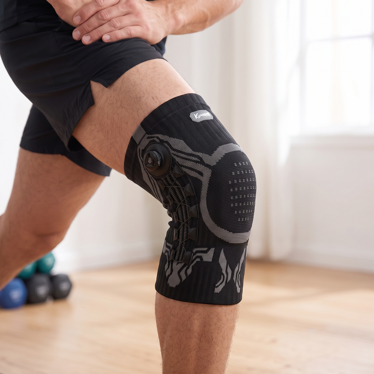 KUANGMI black knee brace worn mid lunge in a bright gym