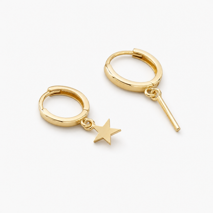 Plain hoop drop earrings laid on a small black velvet pouch on a wooden tray