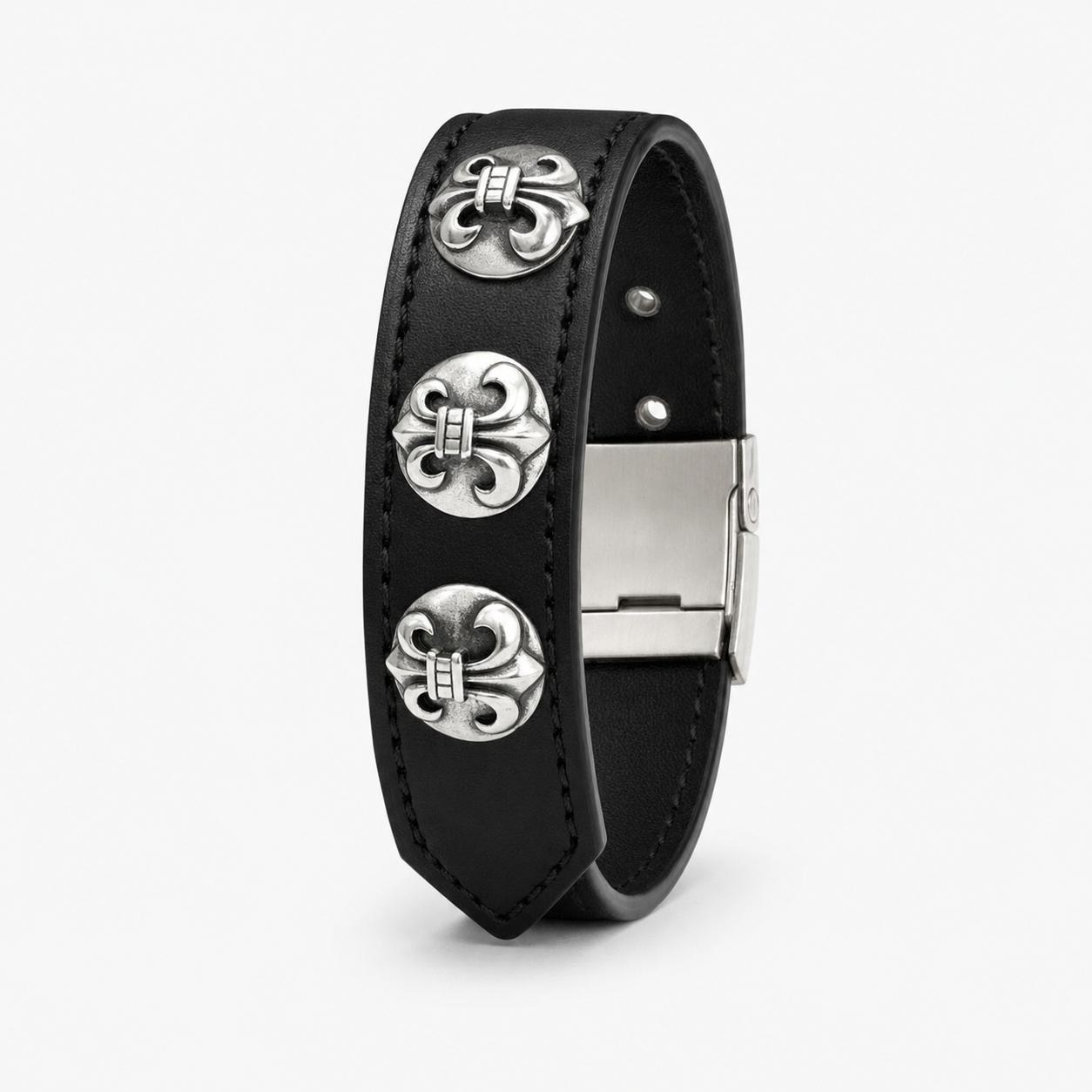 Close up of the silver metal concho riveted onto the smooth black leather