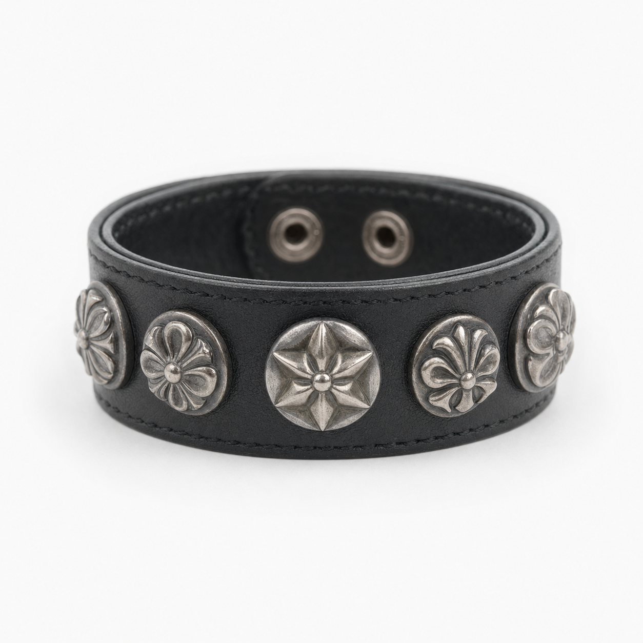 Black leather concho cuff bracelet worn on the wrist as a statement piece