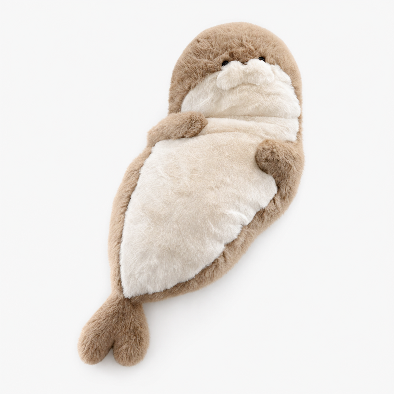 Seal plush toy resting on a bed, shown in a soft naptime setting