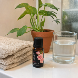 Customer review photo of the rose essential oil bottle on a bathroom shelf