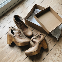Customer unboxing photo of khaki wedge heels